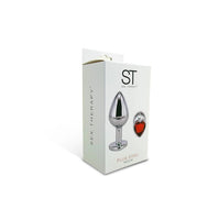 Plug anal metalizado con base de corazon y piedra roja - ST Toys - 7 x 2,7 cm.